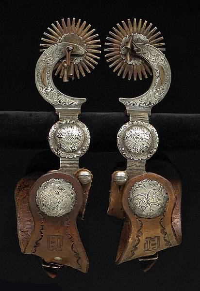 Appraisal: A pair of massive silver-mounted spurs by Garcia Single mounted