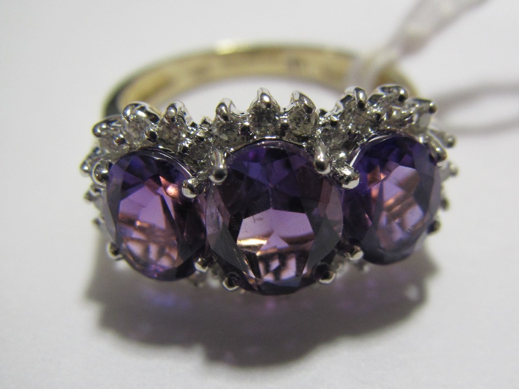 Appraisal: Nine carat gold amethyst and diamond triple cluster ring