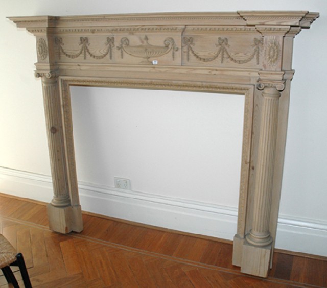 Appraisal: AN ENGLISH CARVED PINE FIRE SURROUND The rectangular reverse breakfront