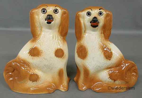 Appraisal: Pair of Staffordshire seated spaniels with glass eyes ''h x