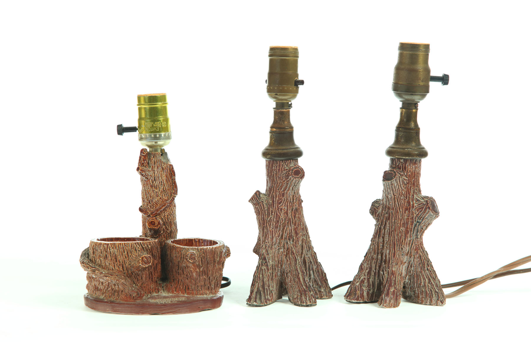 Appraisal: THREE SEWERTILE TREE TRUNK LAMPS Ohio early th century Single