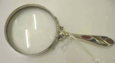 Appraisal: A VICTORIAN MAGNIFYING GLASS the circular lens within beaded EPNS