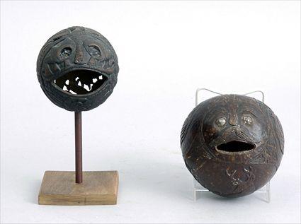 Appraisal: TWO RELIEF-CARVED COCONUT SHELL PENNY BANKS The larger with open