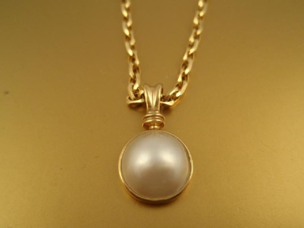 Appraisal: A half pearl bead pendant in ct gold with a