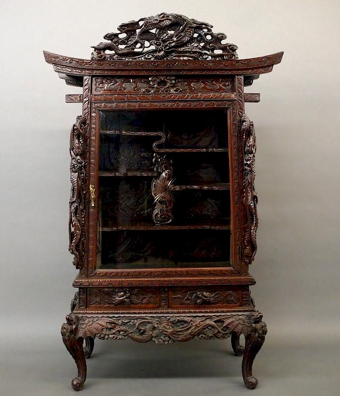 Appraisal: Japanese dragon cabinet An early th century Japanese hardwood Dragon