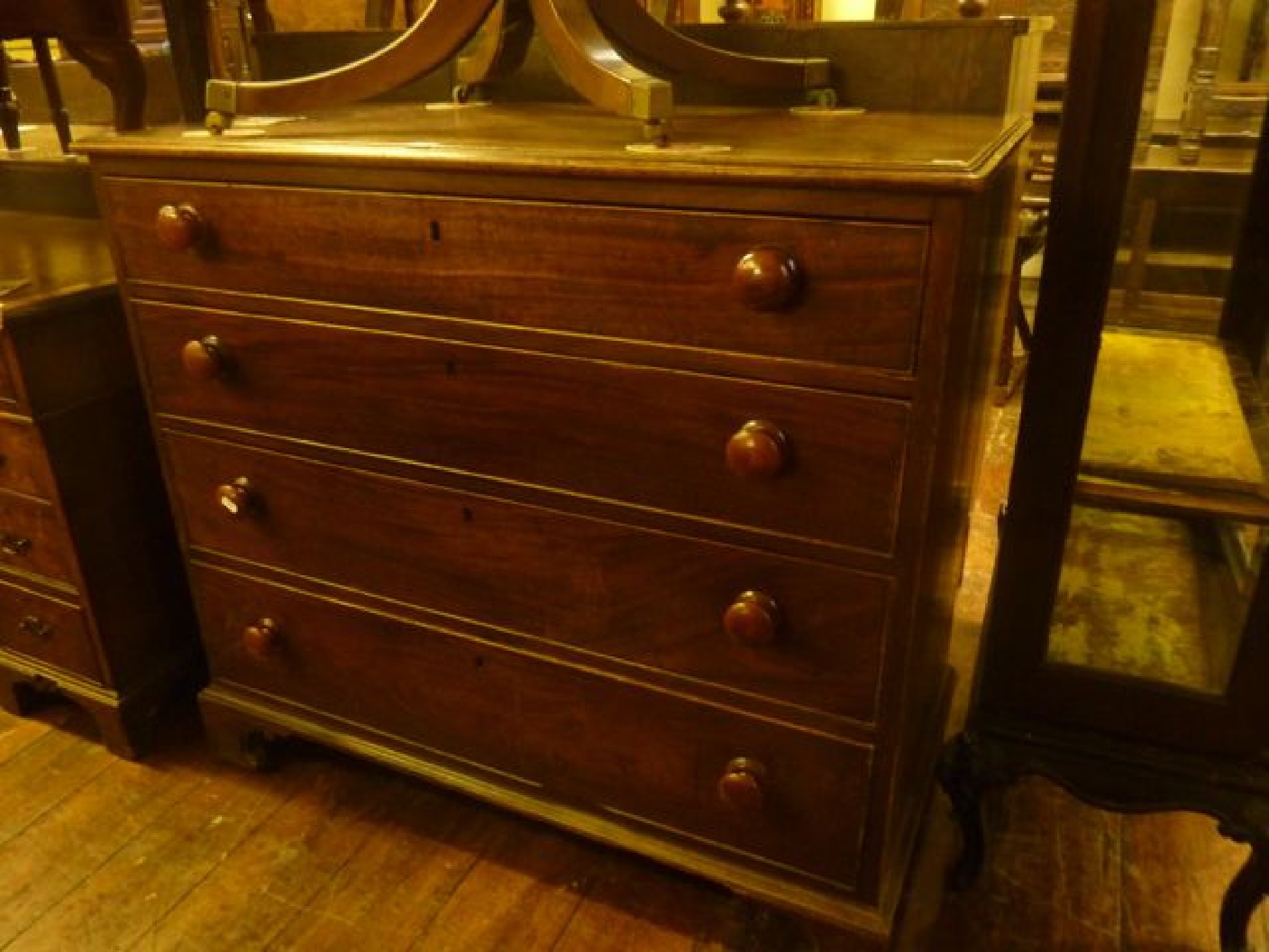 Appraisal: A Georgian mahogany chest of four long graduated drawers the