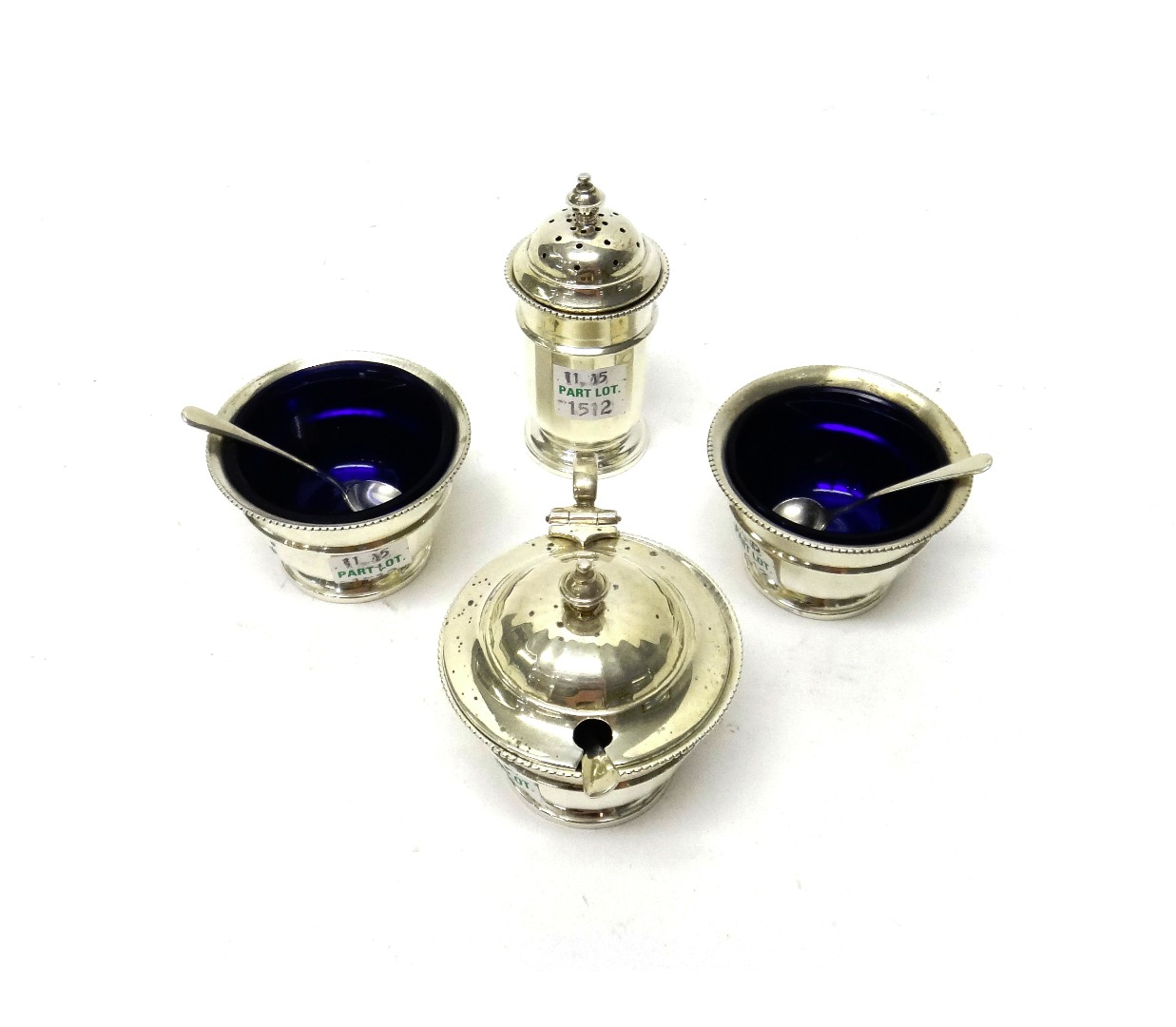 Appraisal: A silver four piece part condiment set comprising a pair