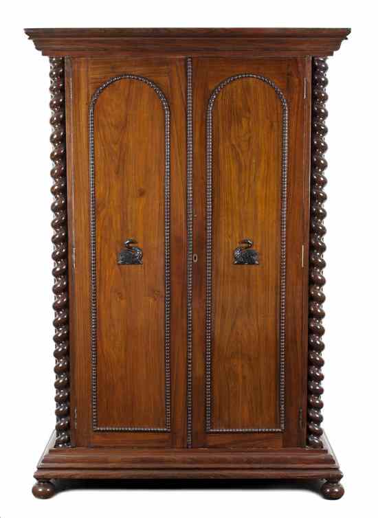 Appraisal: A Colonial Ebonized and Rosewood Armoire having a molded stepped