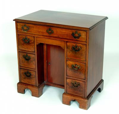 Appraisal: A SMALL GEORGE III MAHOGANY KNEEHOLE DESK the moulded edged