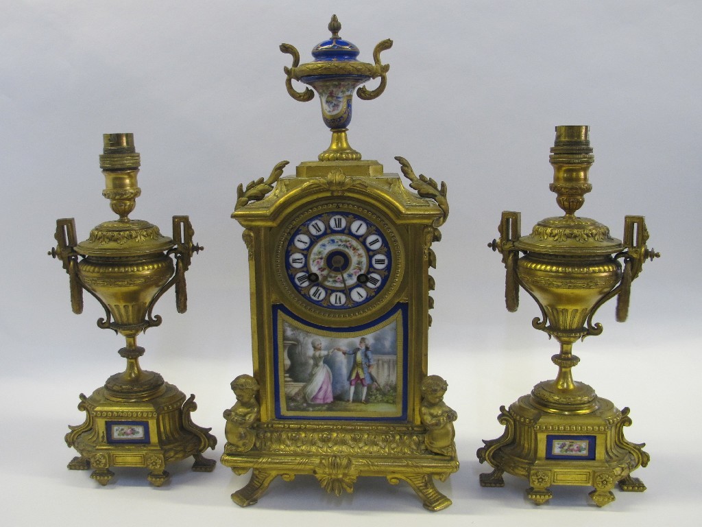 Appraisal: French gilt metal clock garniture with painted porcelain panel depicting