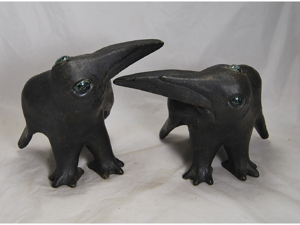 Appraisal: A pair of studio stoneware ravens crows having glazed eyes