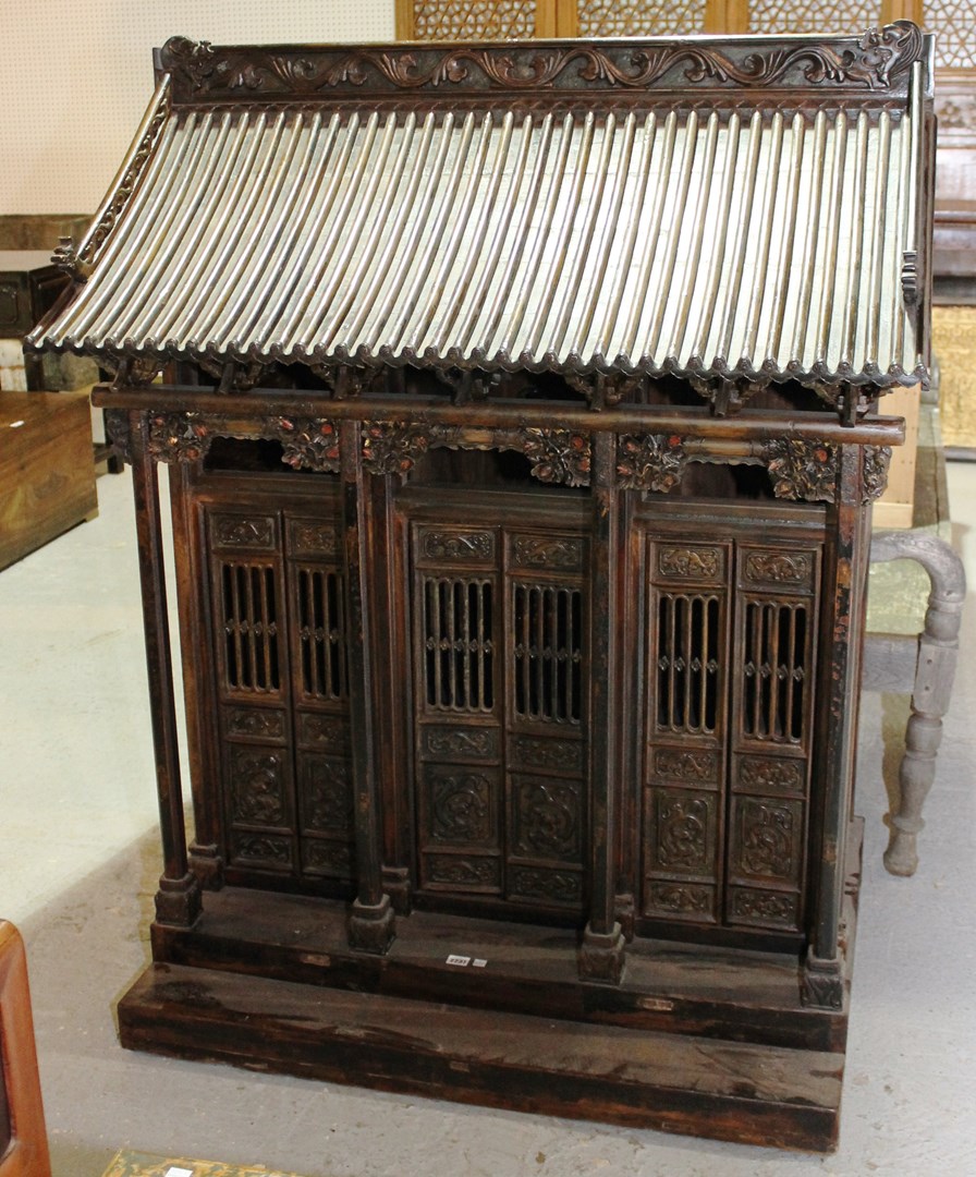 Appraisal: A large th century Eastern carved hardwood shrine cabinet in