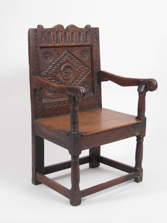 Appraisal: An antique oak Hall Chair with carved panelled back on