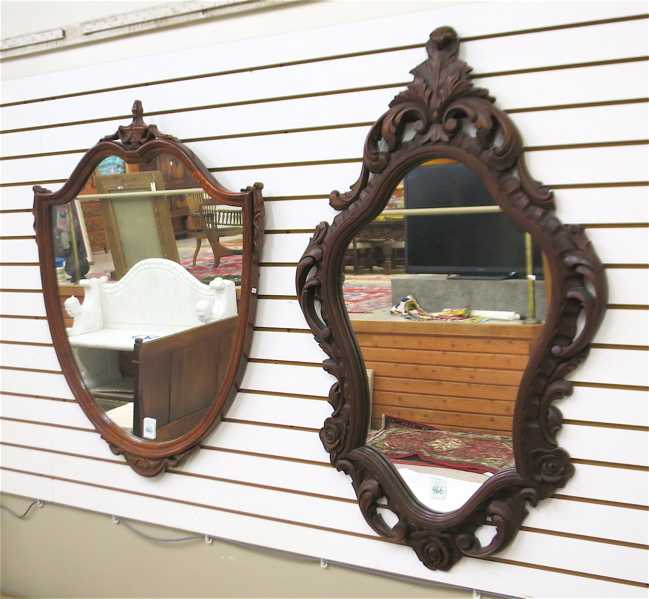 Appraisal: TWO WALL MIRRORS WITH CARVED FRAMES Rococo style cartouche-shaped mirror