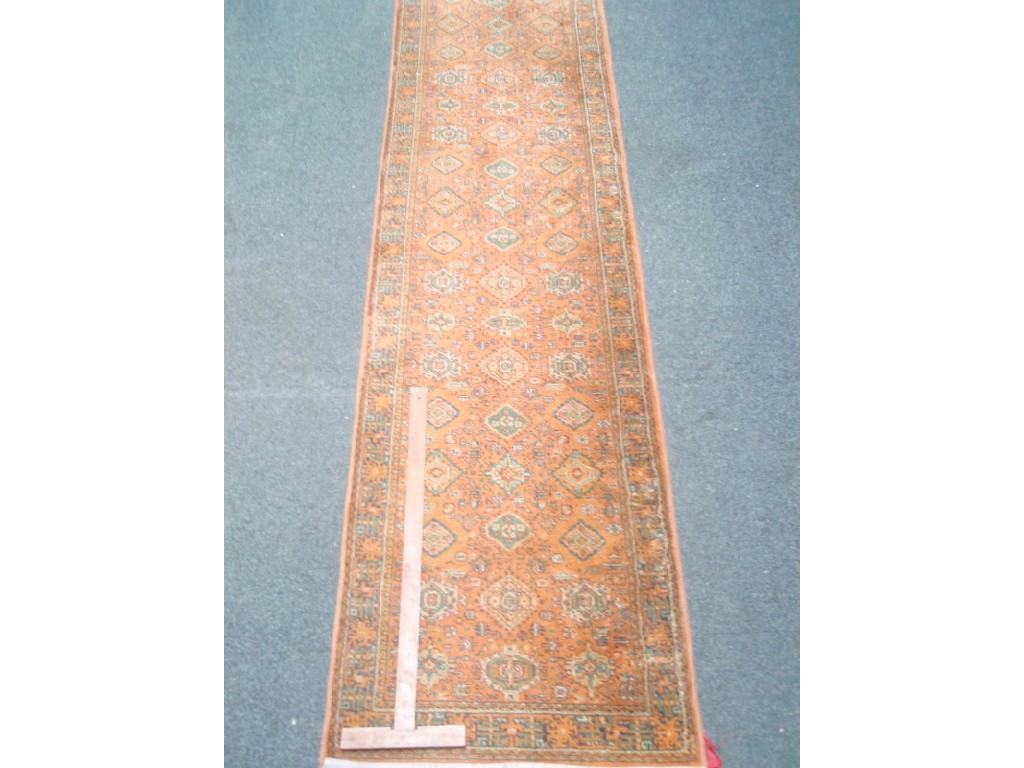 Appraisal: An orange ground Persian design runner cm x cm