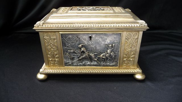 Appraisal: A metal casket jewellery box with cast panels depicting Don