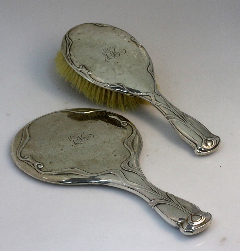 Appraisal: An Art Nouveau style silver backed hand mirror and hairbrush