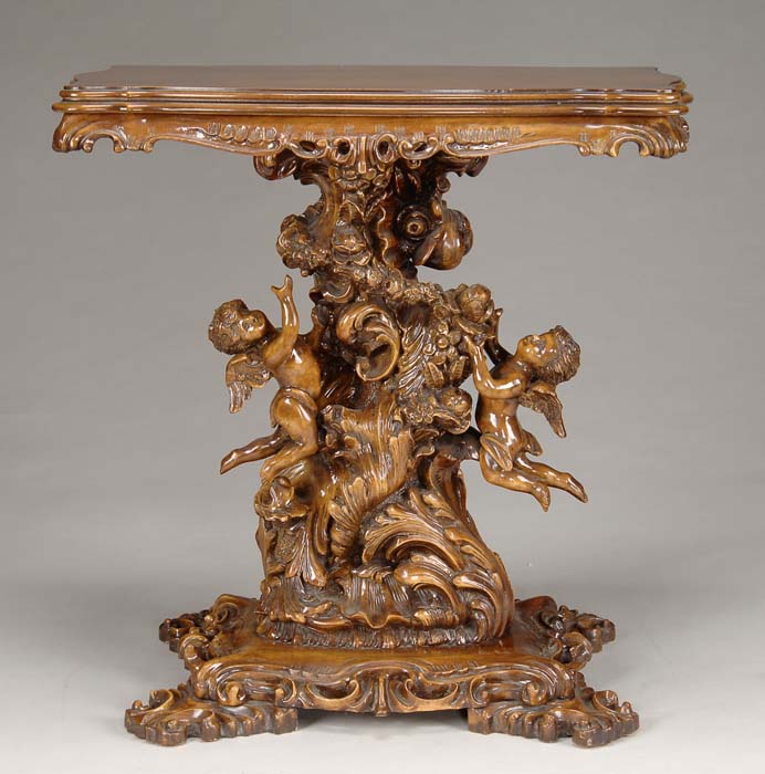 Appraisal: LAVISHLY CARVED CHERUB DECORATED HALL TABLE Shaped rectangular rotating top