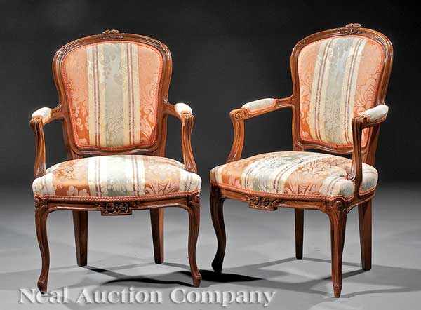 Appraisal: A Pair of Antique Louis XV-Style Carved Walnut Fauteuils late