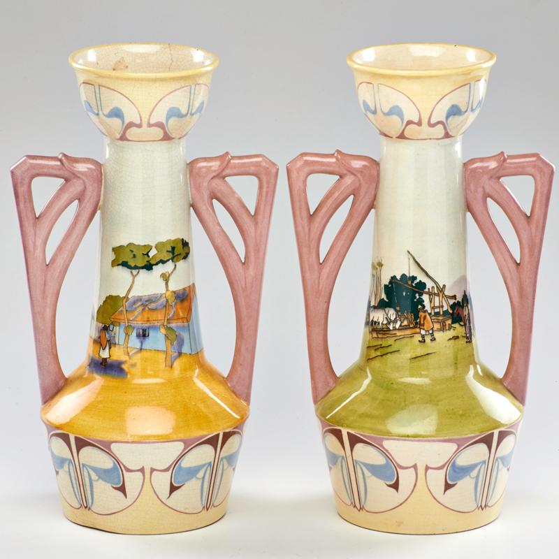 Appraisal: FISCHER BUDAPEST Pair hand-painted vases depicting pastoral scenes Hungary early