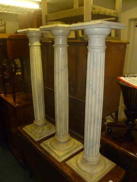 Appraisal: A HARLEQUIN SET OF THREE JARDINIERE STANDS with fluted columns