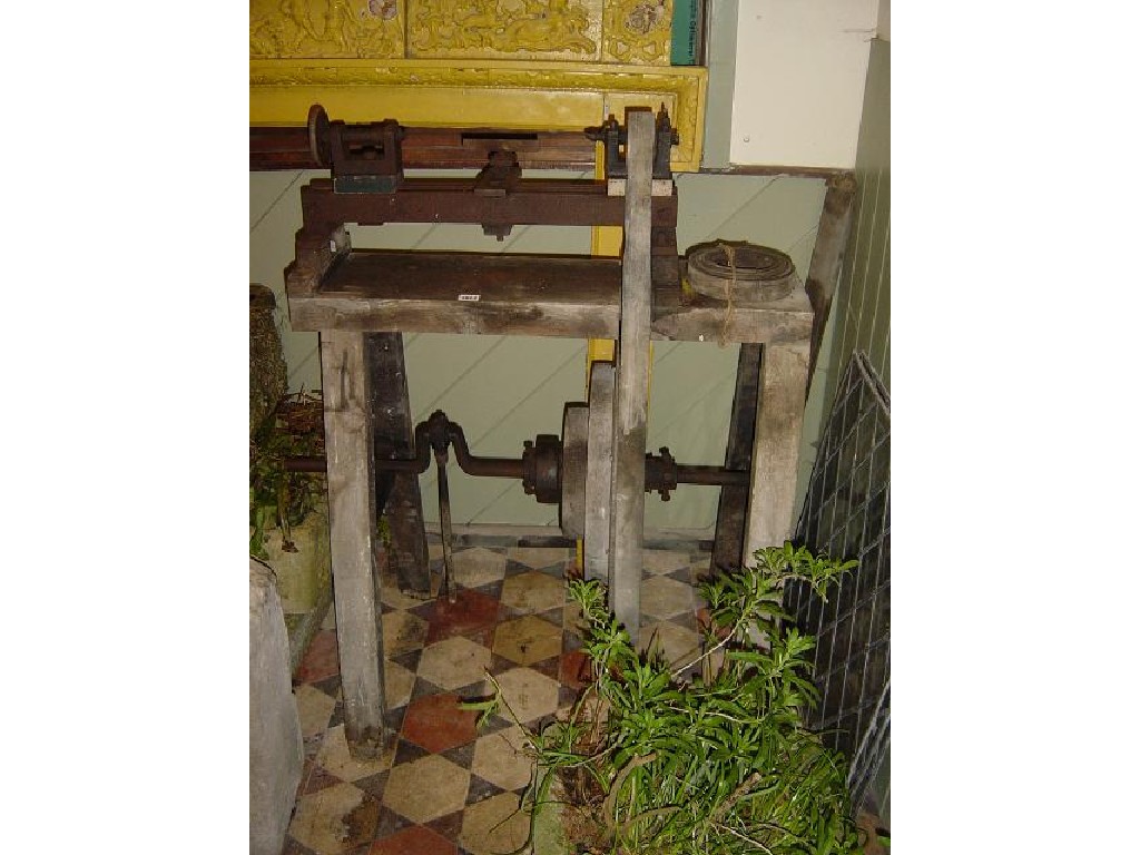 Appraisal: A vintage treadle woodworking lathe raised on a timber framed