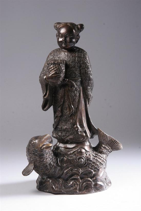 Appraisal: CHINESE BRONZE FIGURAL GROUP Figure standing on carp - in