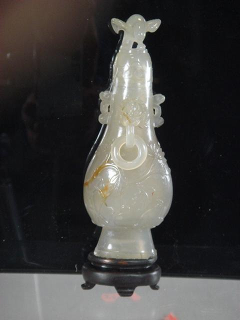 Appraisal: Carved white jade bottle with bird stopper foo dog face