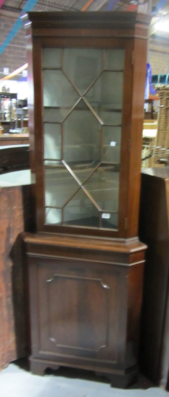 Appraisal: A th century mahogany corner cabinet