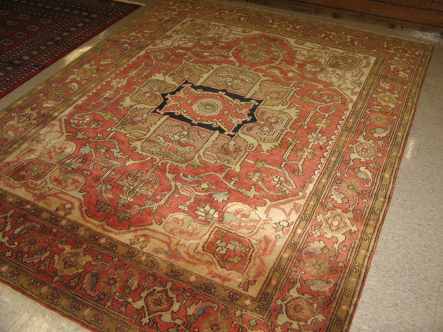 Appraisal: HAND KNOTTED ORIENTAL CARPET antique Serapi design central geometric medallion