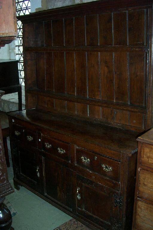 Appraisal: A Georgian elm dresser the upper section fitted with a