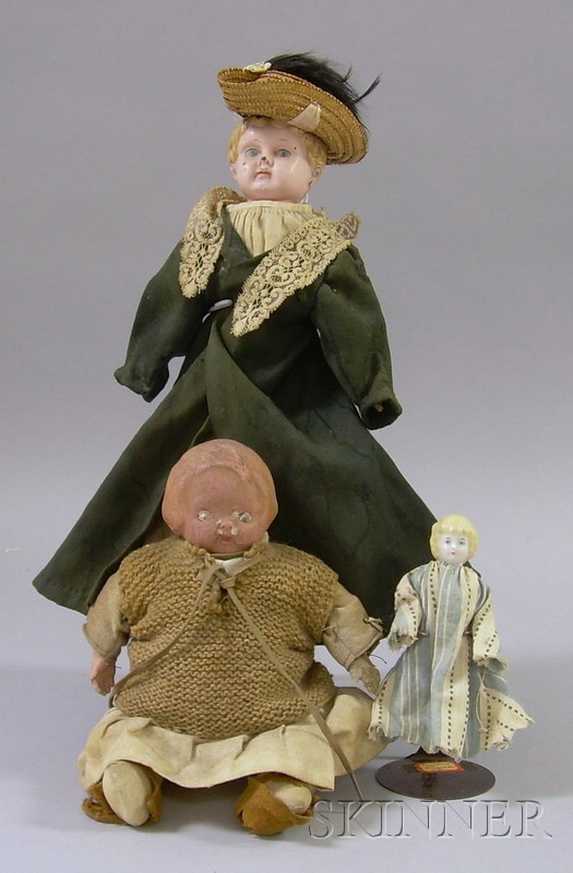 Appraisal: Three Dolls a small blond porcelain doll a tin doll