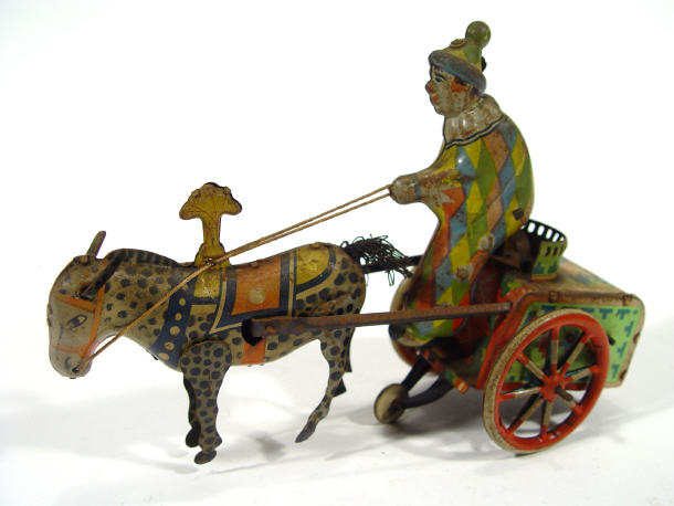 Appraisal: Tinplate clockwork clown on donkey and cart back the donkey