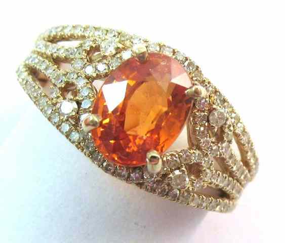 Appraisal: ORANGE SAPPHIRE AND DIAMOND RING k yellow gold ring with