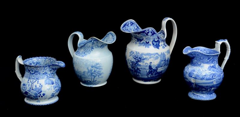 Appraisal: GROUP OF FOUR STAFFORDSHIRE BLUE TRANSFER-PRINTED JUGS Comprising the smallest