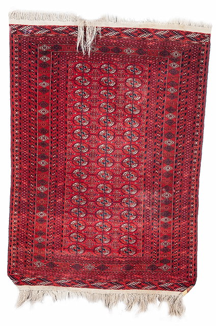 Appraisal: A TEKKE TURKOMAN WINE GROUND RUG decorated three rows of