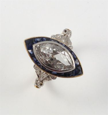 Appraisal: A diamond and sapphire ring The marquise shaped diamond is