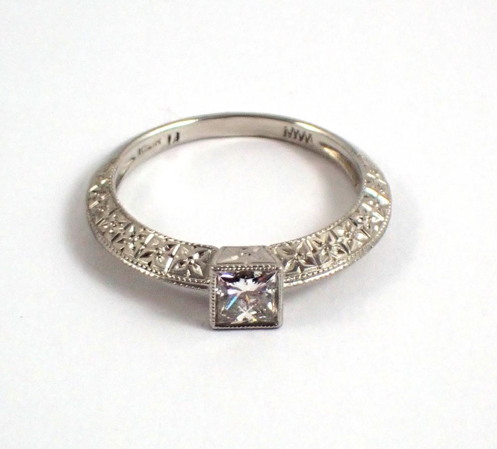 Appraisal: DIAMOND AND PLATINUM SOLITAIRE RING bezel set with a ct