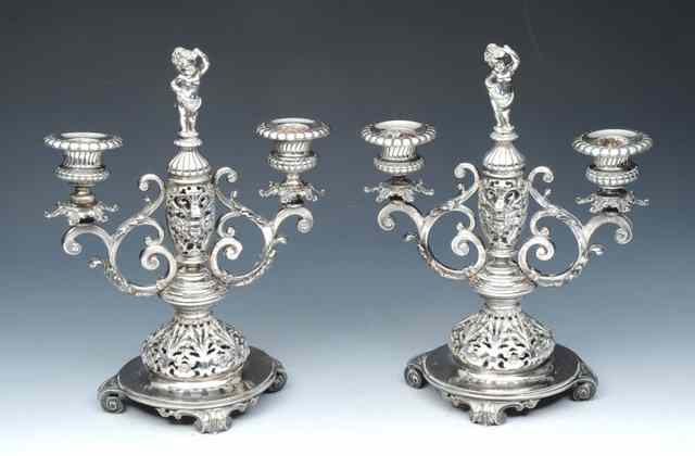 Appraisal: A PAIR OF AUSTRIAN SILVER TWO BRANCH CANDLEABRA with pierced