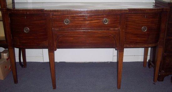 Appraisal: A George III mahogany breakfront sideboard the crossbanded top fitted