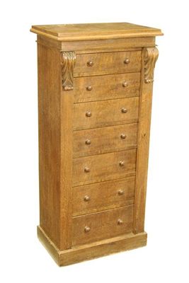 Appraisal: A Victorian oak Wellington chest having seven drawers and a