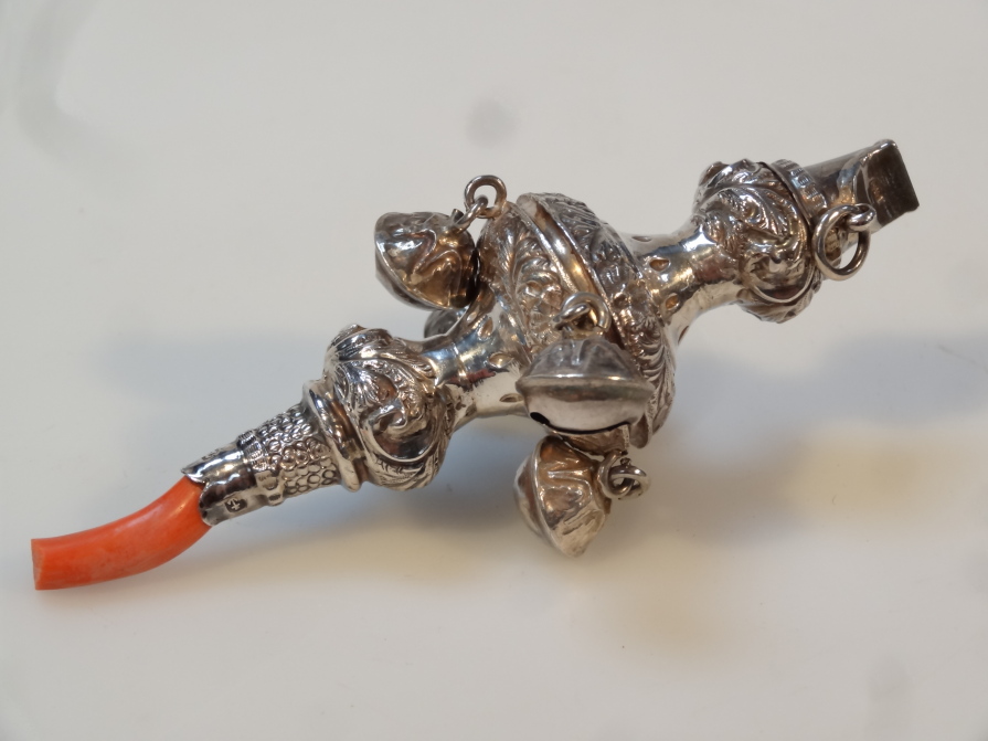 Appraisal: A Victorian silver child's rattle with teething end part repouss