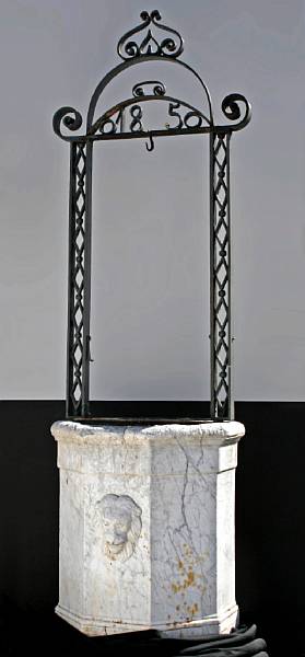 Appraisal: A French Neoclassical style carved marble and iron wellhead th