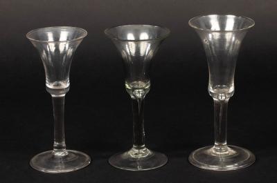 Appraisal: Two th Century wine glasses with trumpet bowls on tear