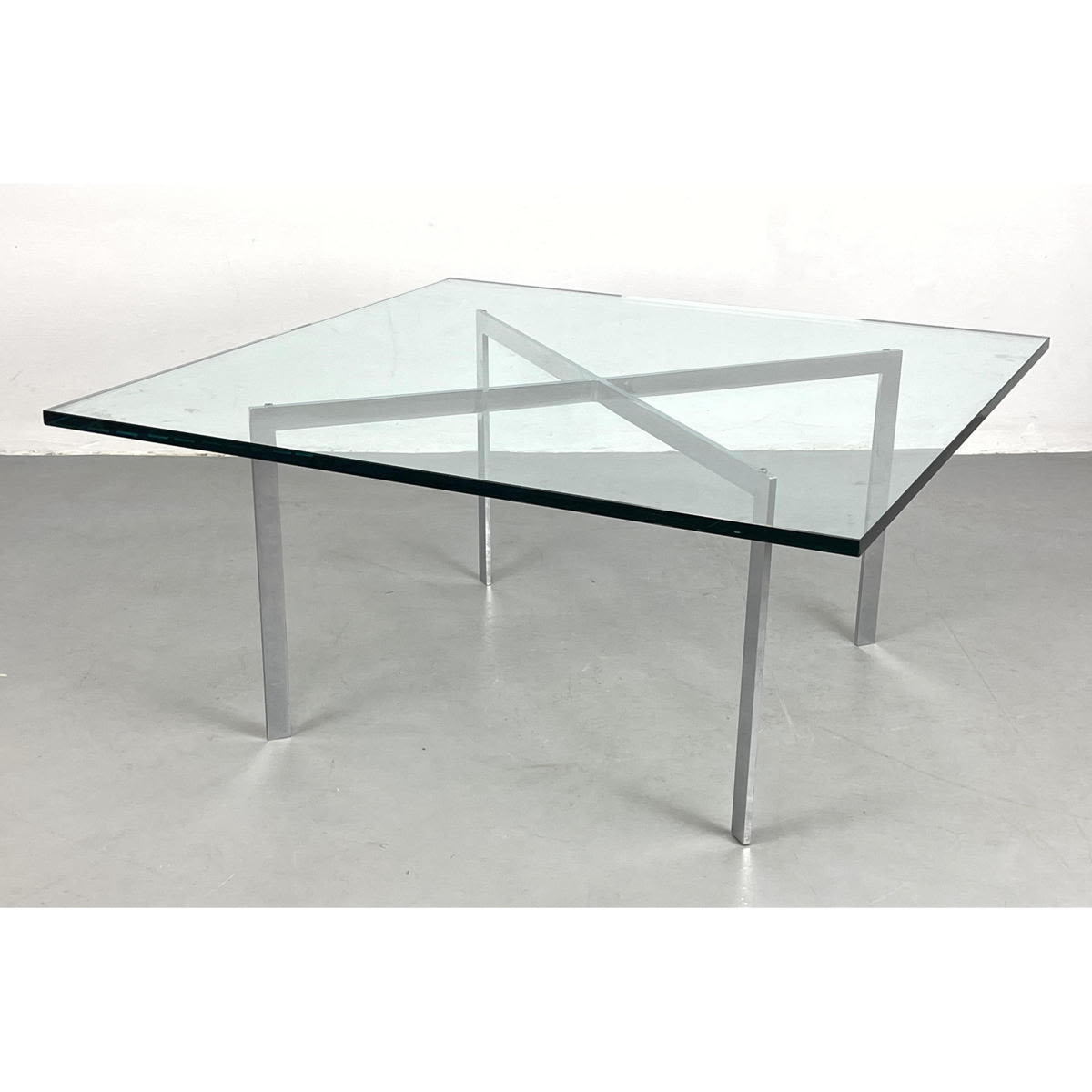 Appraisal: Barcelona style chrome glass cocktail table Dimensions H inches W