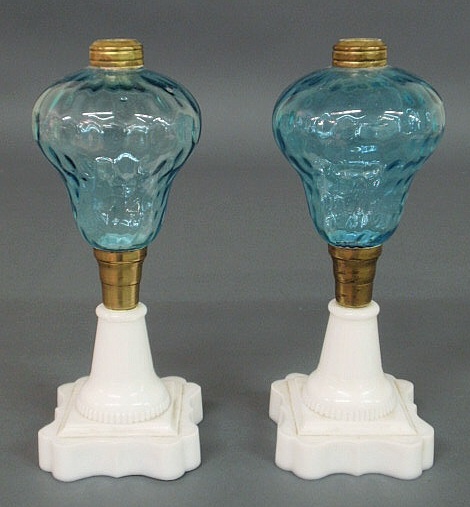 Appraisal: Pair of oil lamps with blue glass fonts and clam