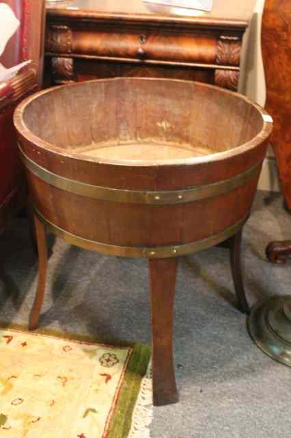 Appraisal: AN OAK PLANTER of circular form on swept supports and