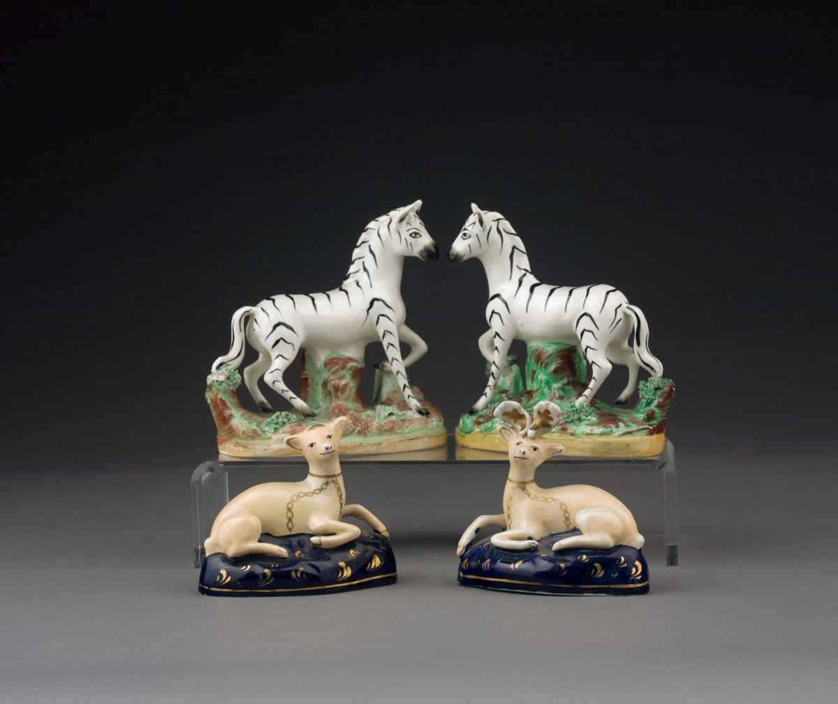 Appraisal: PAIR OF STAFFORSHIRE FIGURES OF ZEBRAS LATE NINETEENTH CENTURY Naturalistically