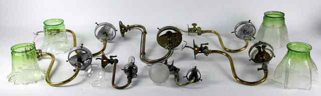 Appraisal: Four brass wall lights with scroll shaped supports and glass