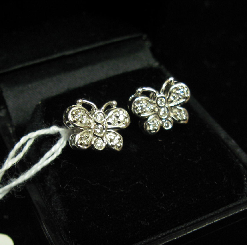 Appraisal: PAIR OF DIAMOND AND FOURTEEN KARAT WHITE GOLD BUTTERFLY EARRINGS